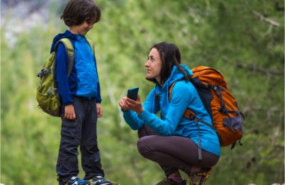 Mom showing son how to use phone