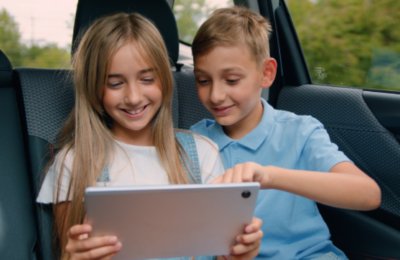 kids in car using tablet device