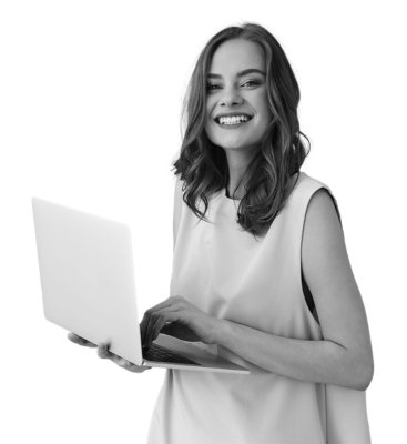 Girl typing on laptop and smiling at the camera