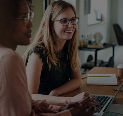 Two woman at work on a laptop