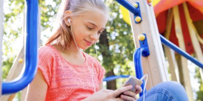 Girl on playground looking at phone