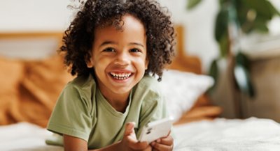 Young boy playing on mobile phone