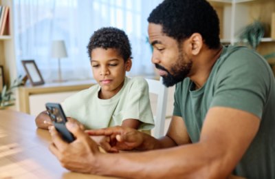 Father teaching son how to use the internet